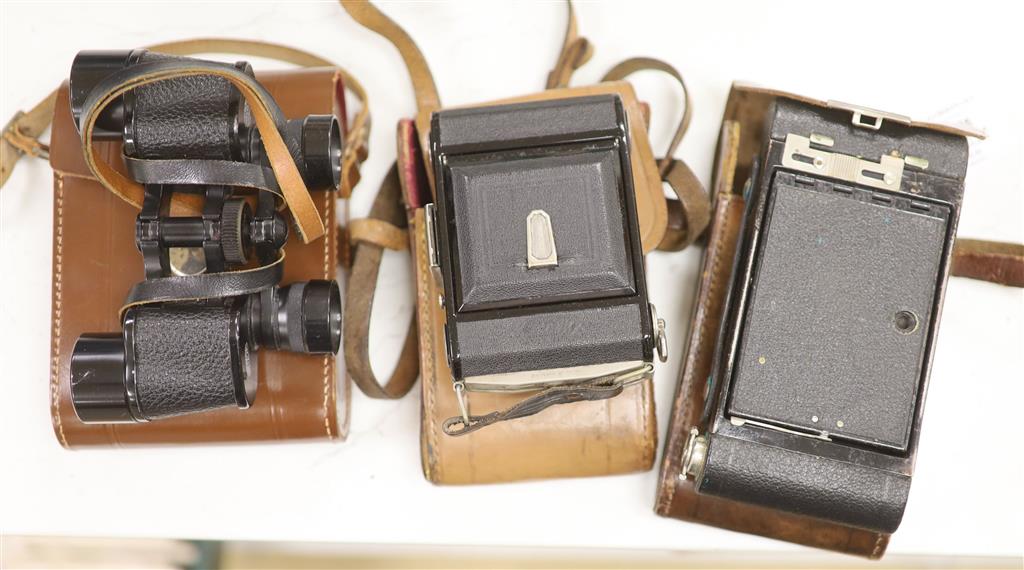 A Kodak Autograph camera, another camera and binoculars